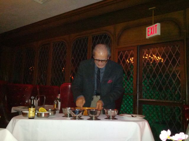 Felix Rinaldi prepares Caesar salad dressing by hand.